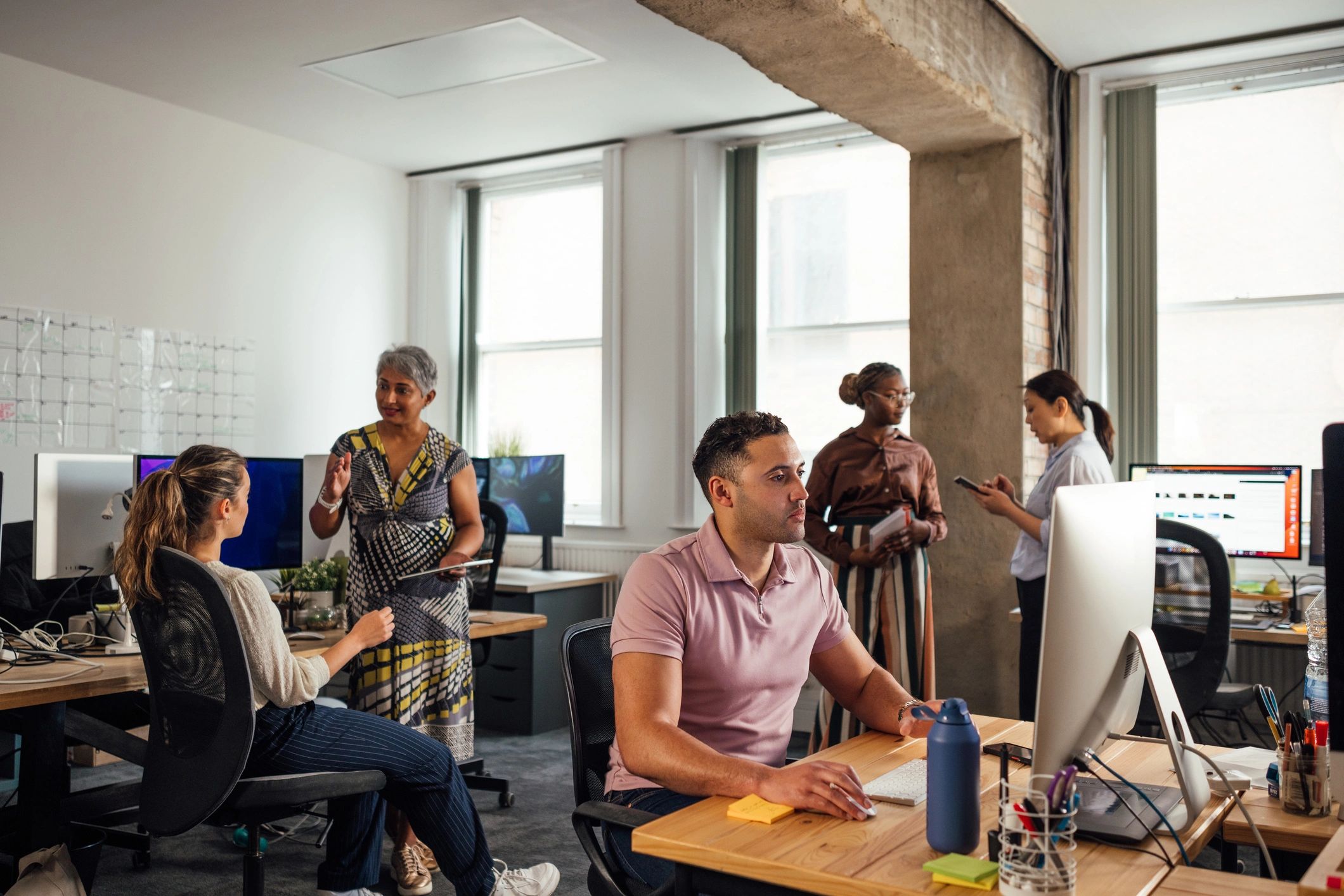 Operations team working at computers representing crisis support