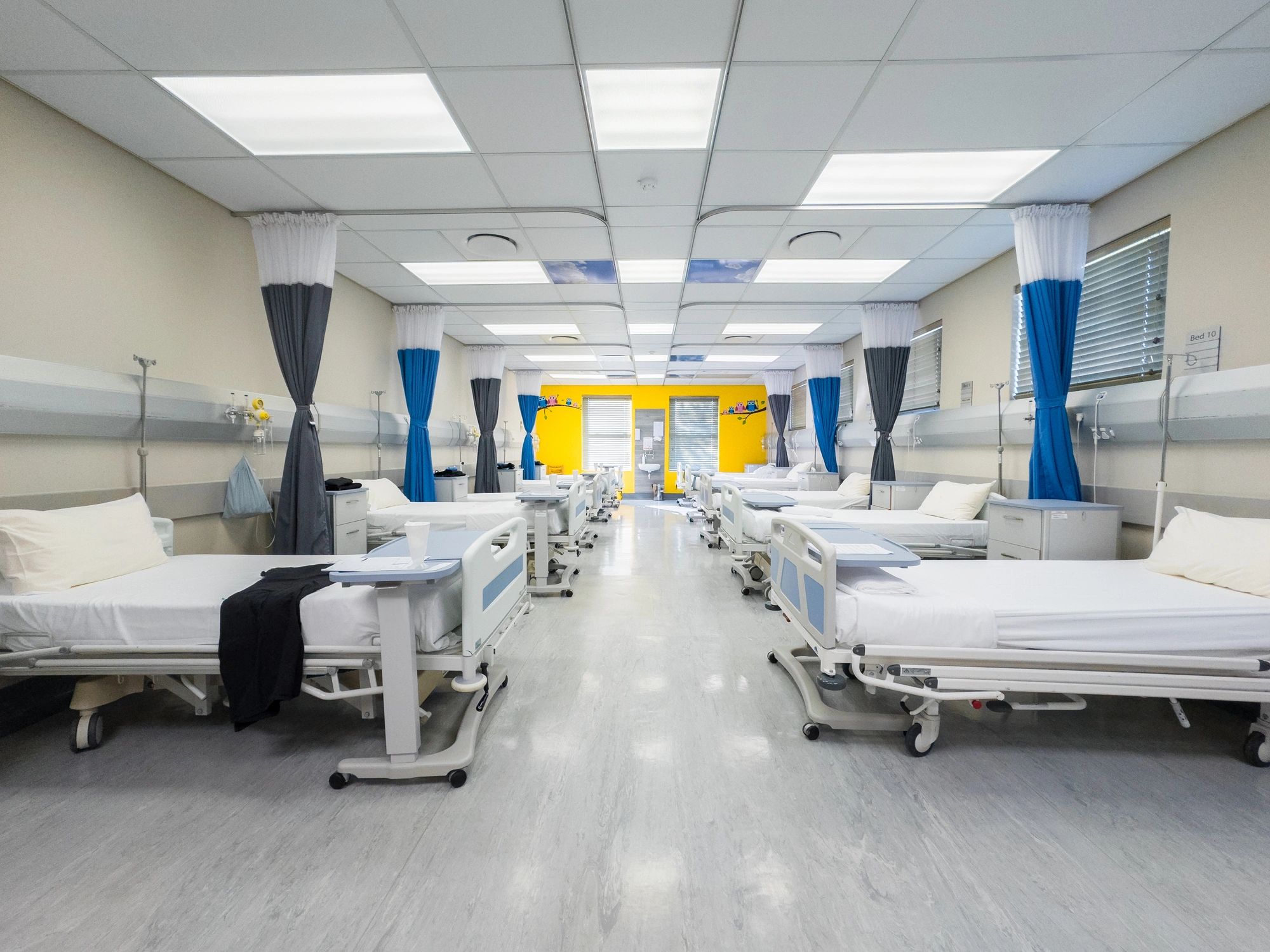 Hospital beds in a medical ward representing healthcare logistics