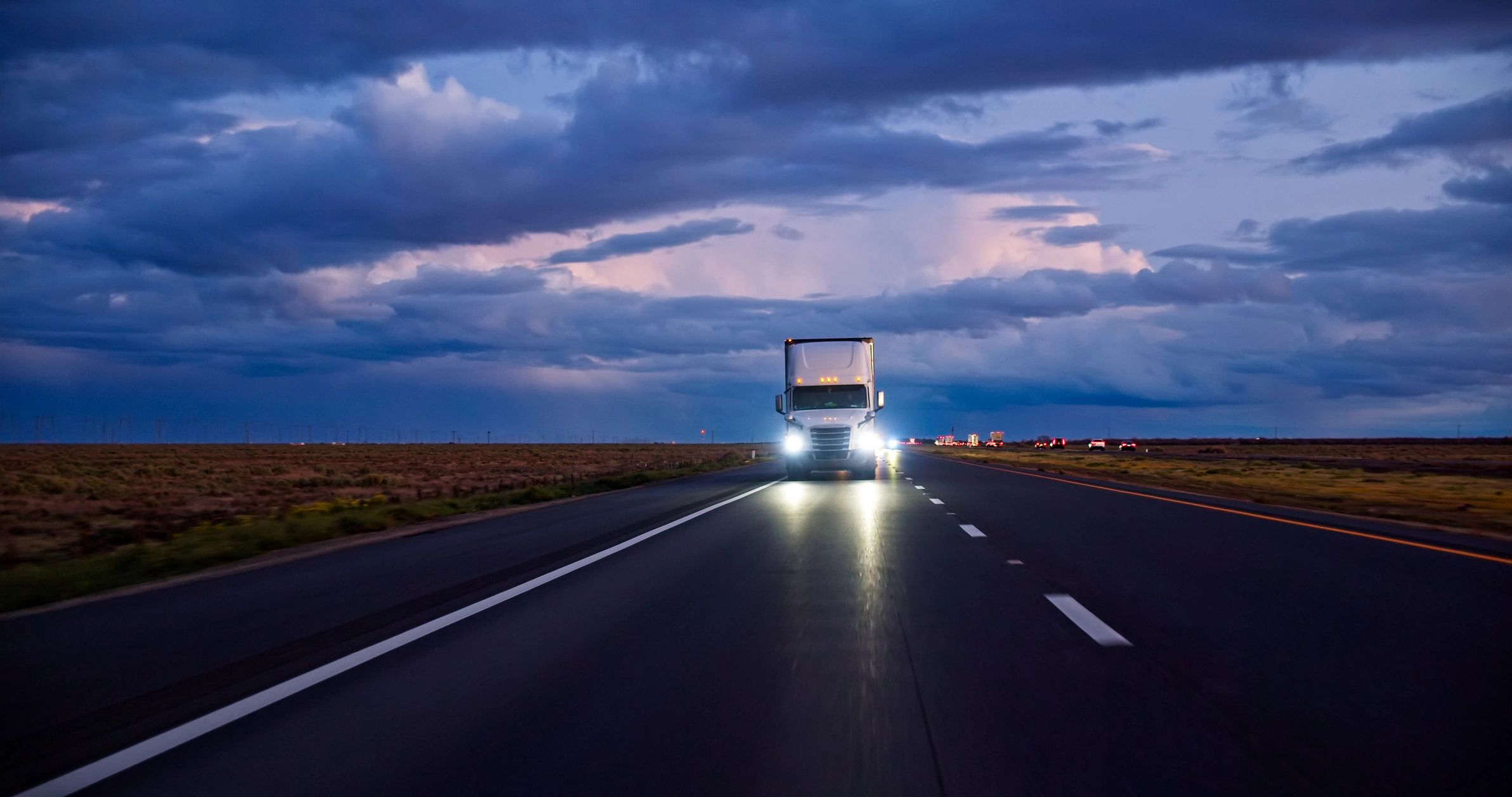 Cargo truck on highway at dusk representing secure ground transport