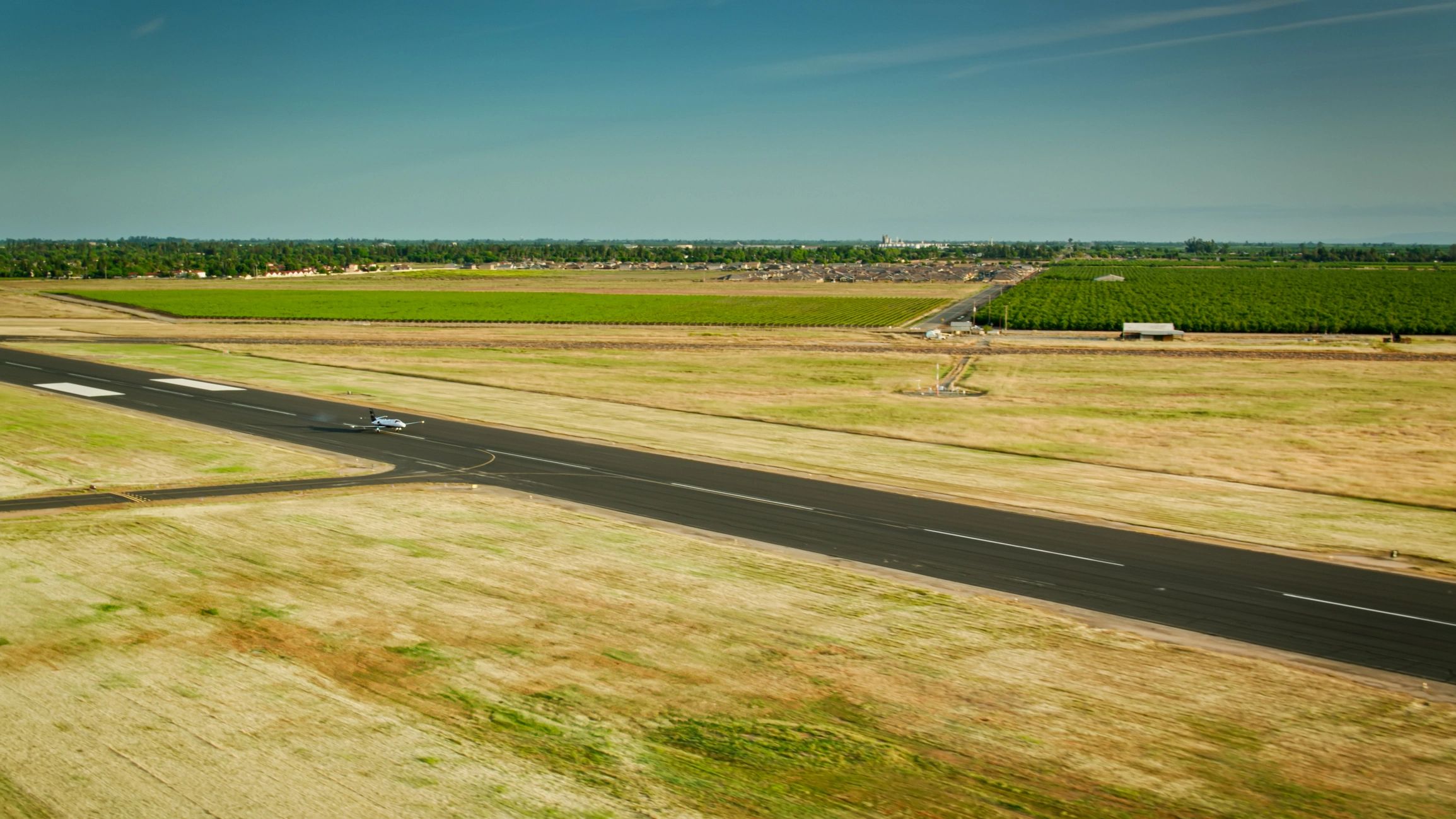 Business jet taxiing on a runway at a small airport