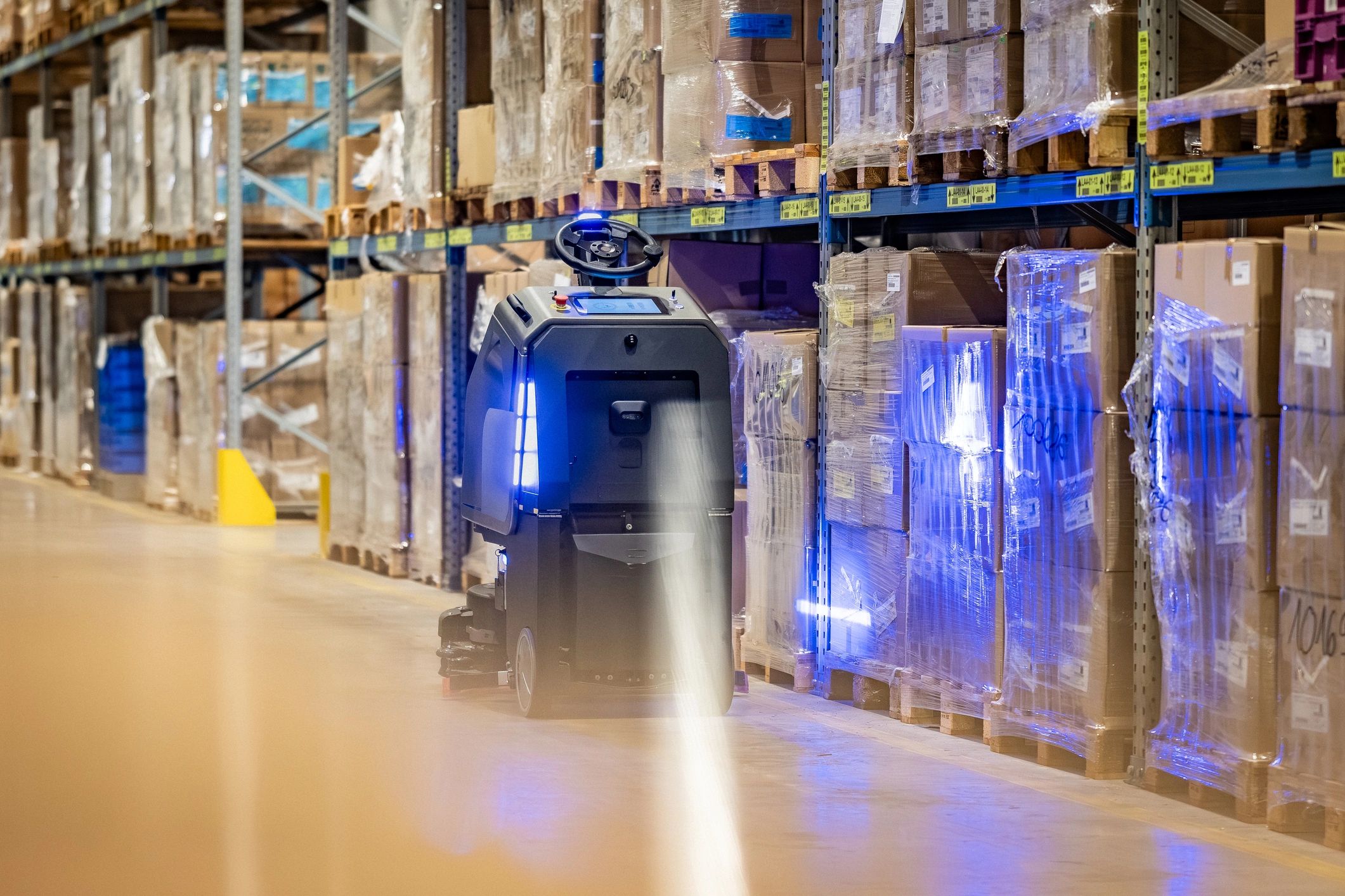 Modern warehouse aisle representing secure, coordinated supply operations